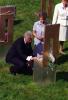 Oklahoma City Memorial President Clinton stoops down and touches a chair at the Oklahoma City National Memorial