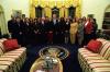 President Clinton joins the staff of the Press Secretary's Office for a group photo in the Oval Office