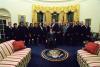 President Clinton joins the staff of the Public Liaison Office for a group photo in the Oval Office