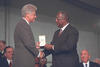 President Clinton presents the Presidential Citizens Medal to Henry "Hank" Aaron. President Clinton Shakes Aaron's hand with his right hand and confers the award with his left hand. 