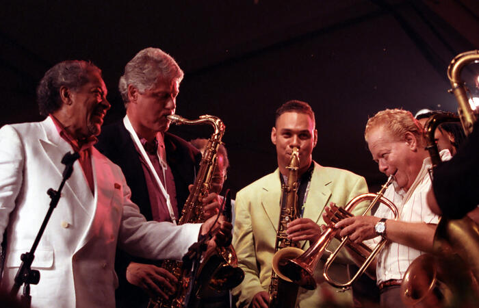 President Clinton plays the saxophone with jazz musicians at the 14th anniversary of the Newport Jazz Festival on the South Grounds