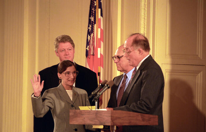 President Clinton participates in the swearing in ceremony of Judge Ruth Bader Ginsburg as Associate Supreme Court Justice. Chief Justice Judge William Renquist administers the oath of office. Judge Ginsburg's husband Marty Ginsburg holds the bible