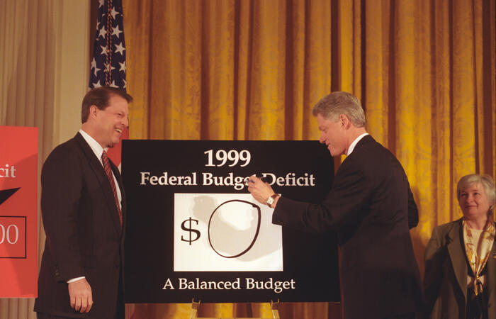 President Clinton and Vice President Gore unveil the 1999 Budget. Council of Economic Advisors Chair Janet Yellen stands in the background in the East Room of the White House
