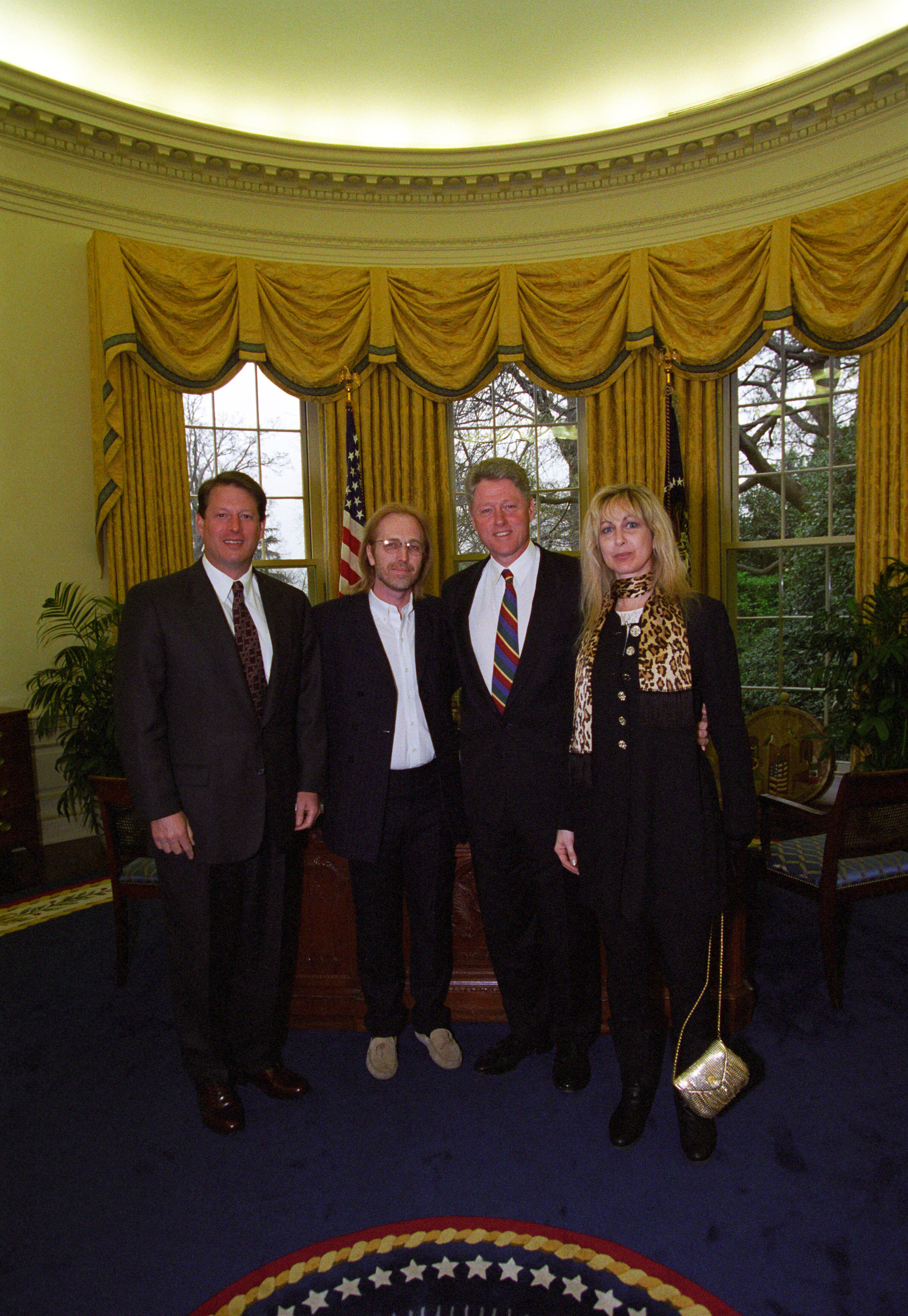 President Clinton and Vice President Gore pose for a photo with musician Tom Petty and wife Jane Petty in the Oval Office