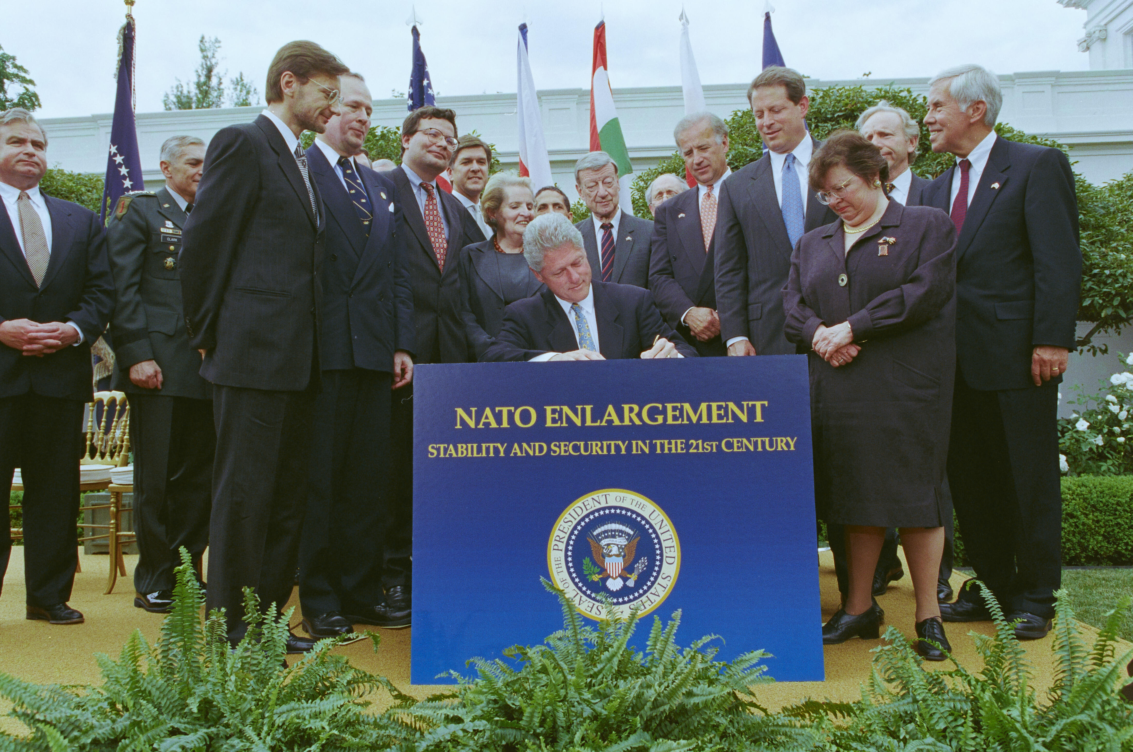 President Clinton signs a message to the Senate regarding the Ratification of the Protocols for Enlargement of the North Atlantic Treaty Organization (NATO). Dias participants include Sec. Madeleine Albright, Leon Fuerth, Sen. Barbara Mikulski, Sen. Richard Lugar, Jeremy Rosner, Sandy Berger, Vice President Gore, and others