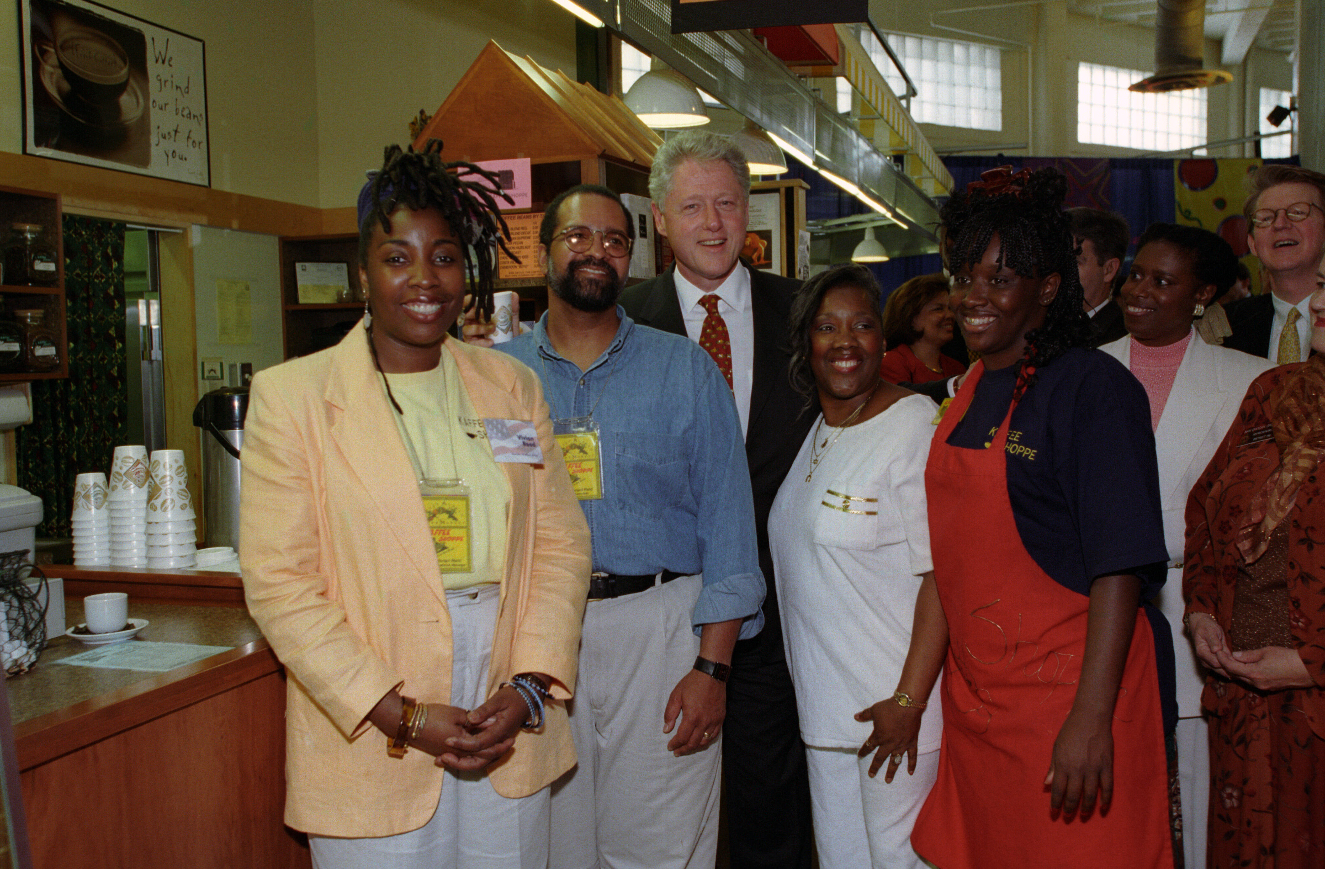 President Clinton stands in the center with shop owners and vendors of the Sweet Auburn Market in Atlanta, Georgia