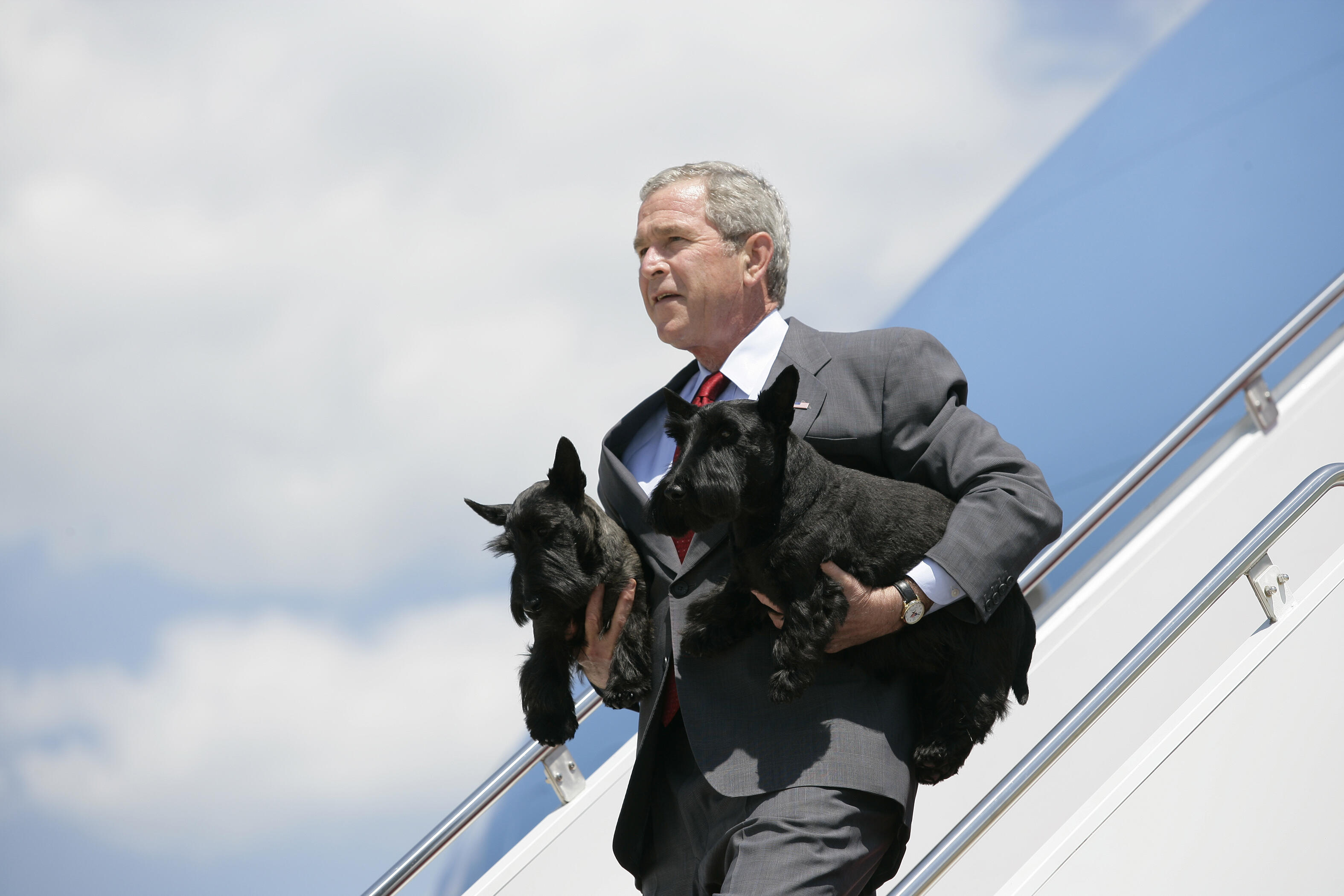 President George W. Bush Arrives at Andrews, AFB with his dogs Barney and Beazley in his arms