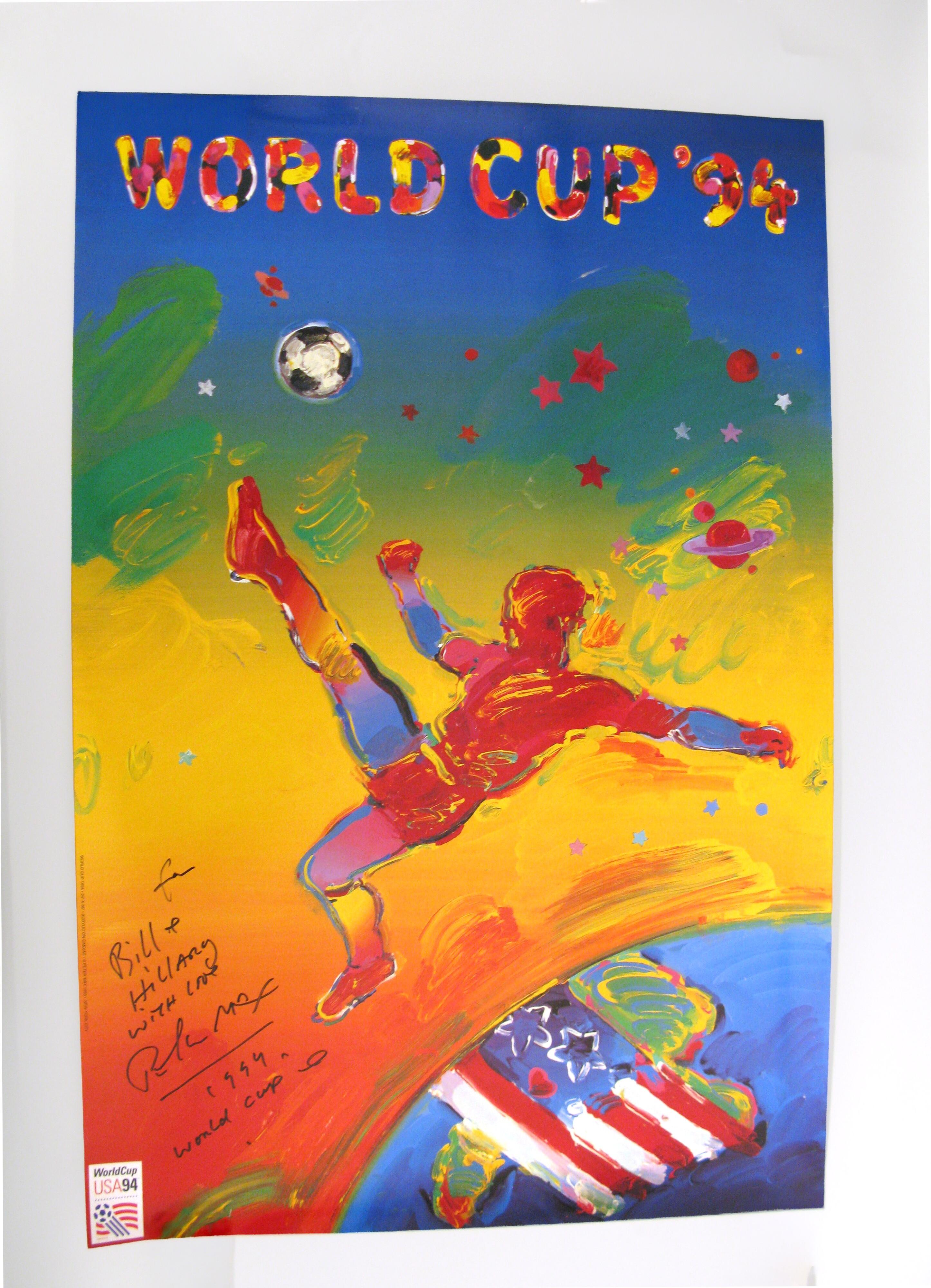 A colorful art poster by Peter Max for World Cup '94 is displayed horizontally, featuring a stylized soccer player mid-kick in the center. The player is silhouetted in a vibrant red and outlined in bright blue, leaping across a bright yellow background. On the left side, the text "WORLD CUP '94" is written vertically in multi-colored, bubbly lettering against a blue border. The background transitions through blue, green, yellow, and red brushstrokes, decorated with scattered stars and planets…