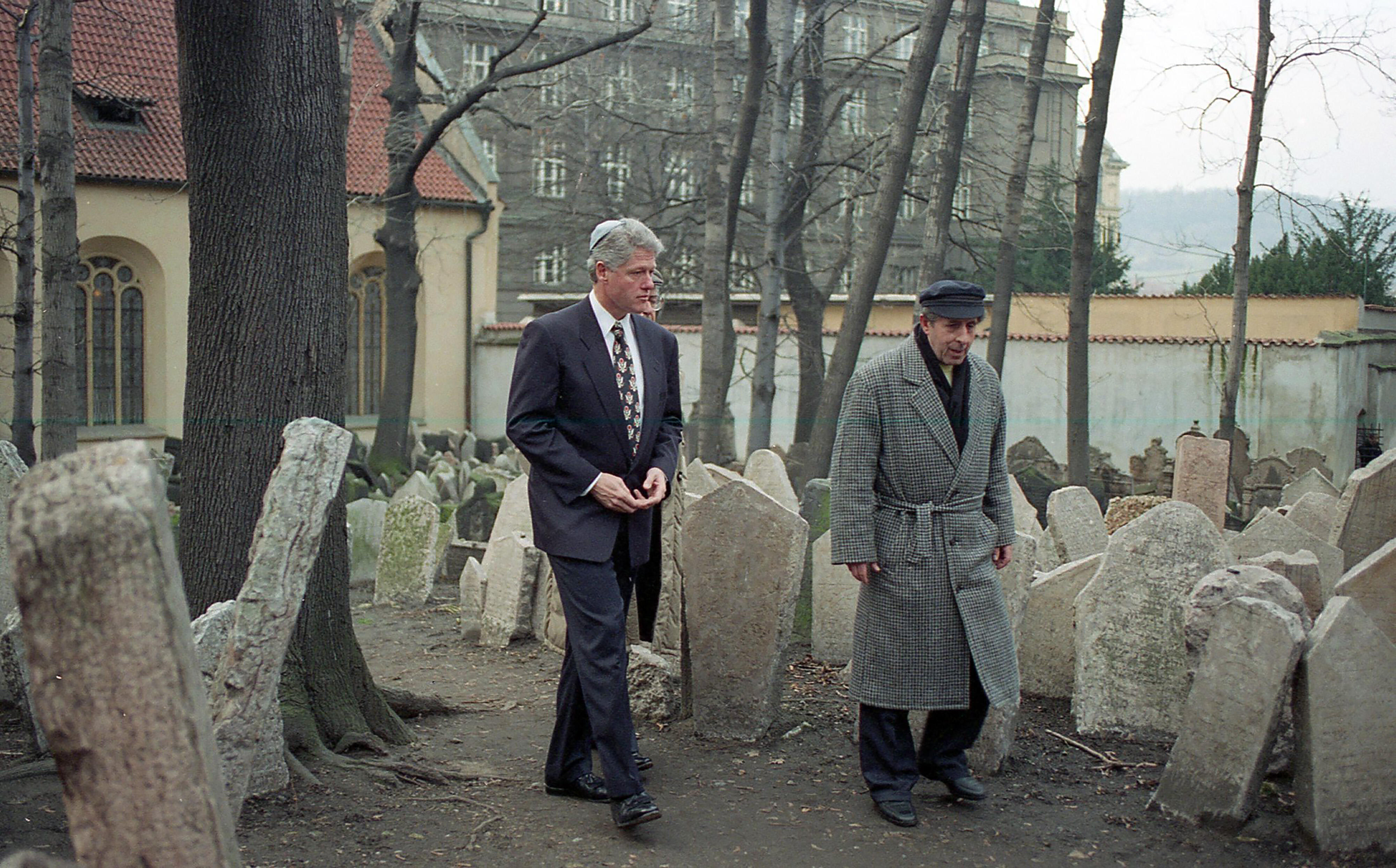 President Clinton visits the historic Old Jewish Cemetery and walks among the graves in Prague with tour guide, Jaroslav Safranek