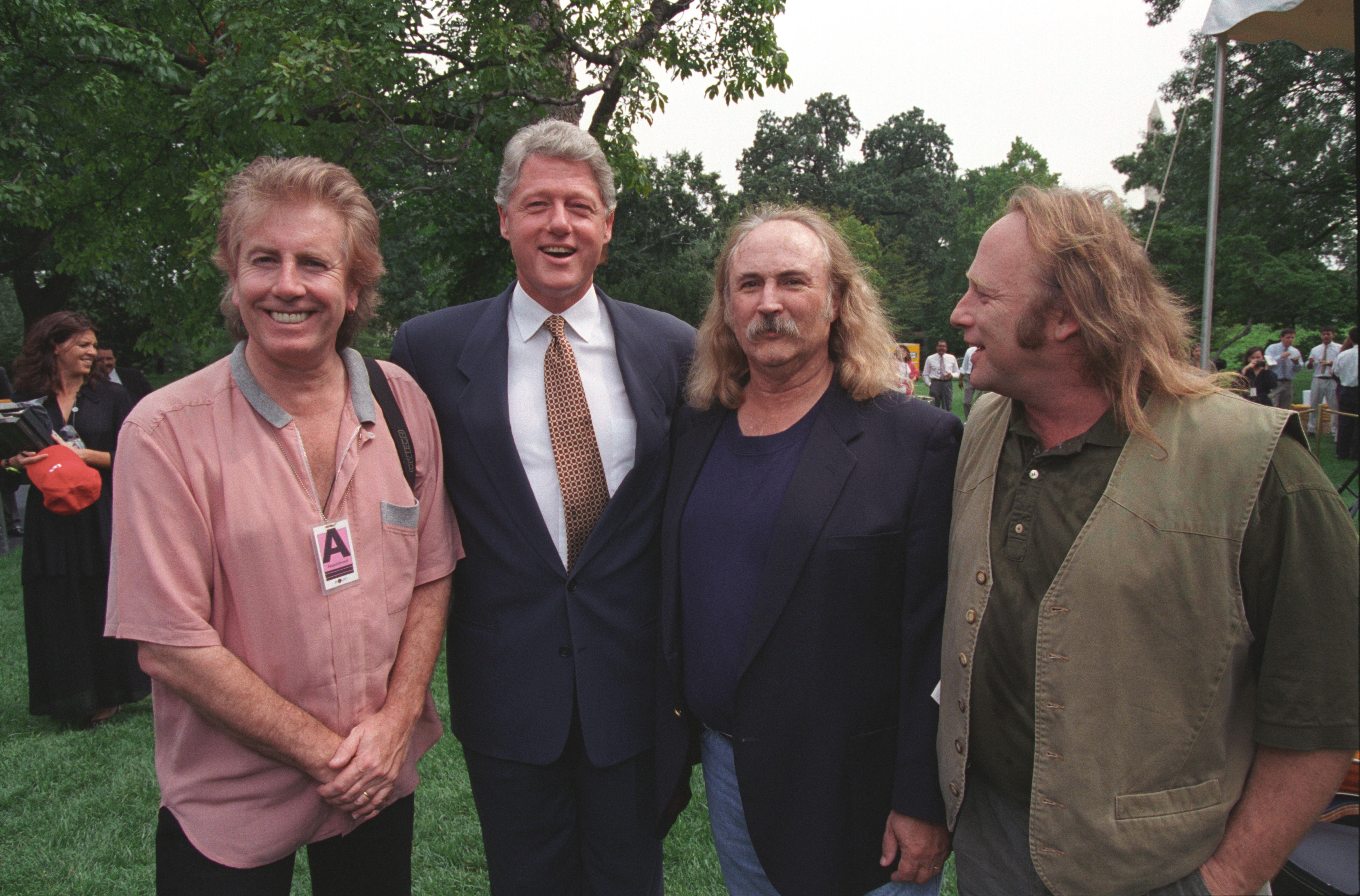 President Clinton poses for a photo on the South Lawn with musicians Stephen Stills, David Crosby, and Graham Nash