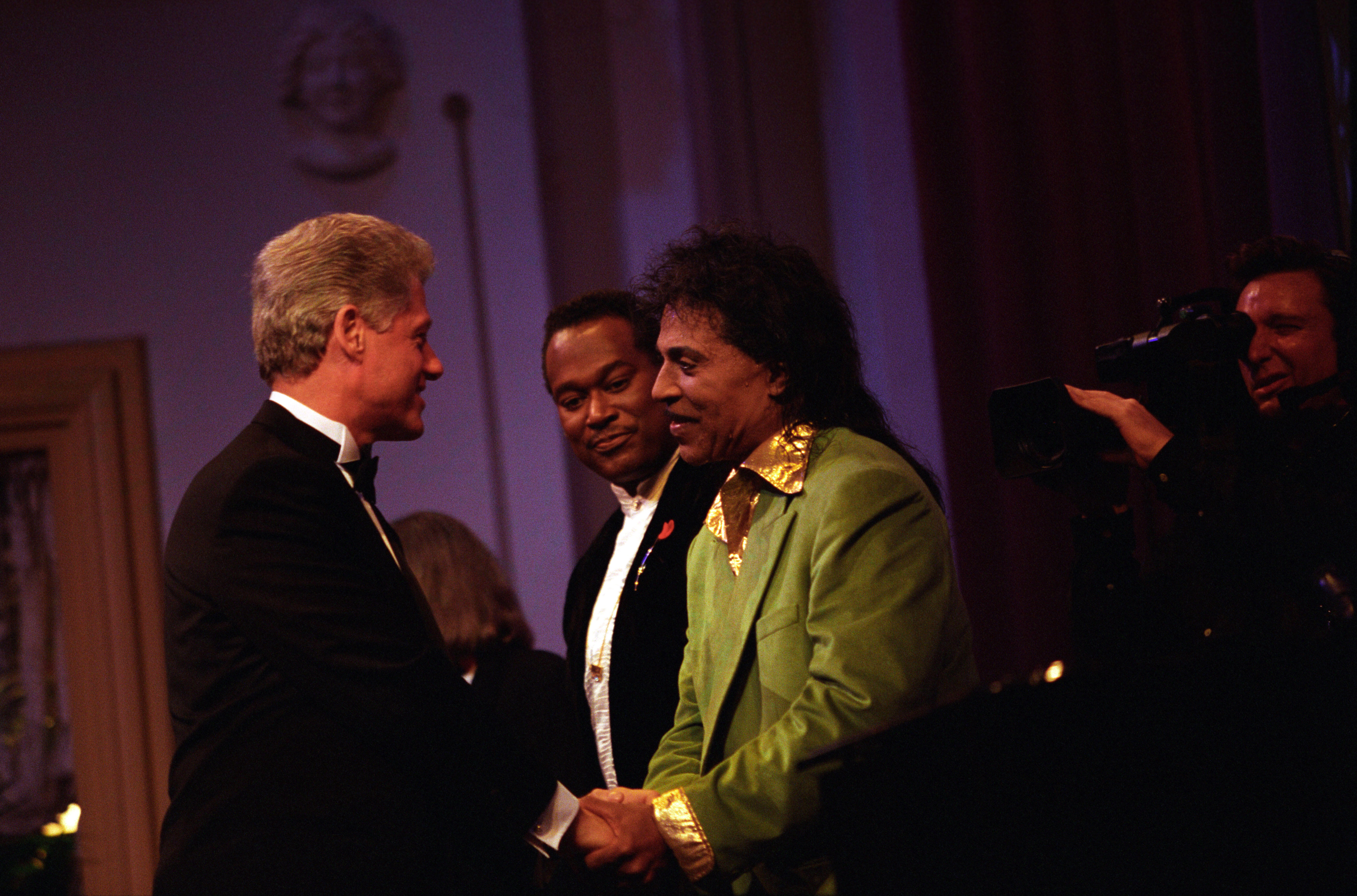 President Clinton greets musician Little Richard and Luther Vandross on stage at the Ford's Theatre Gala in Washington, DC.