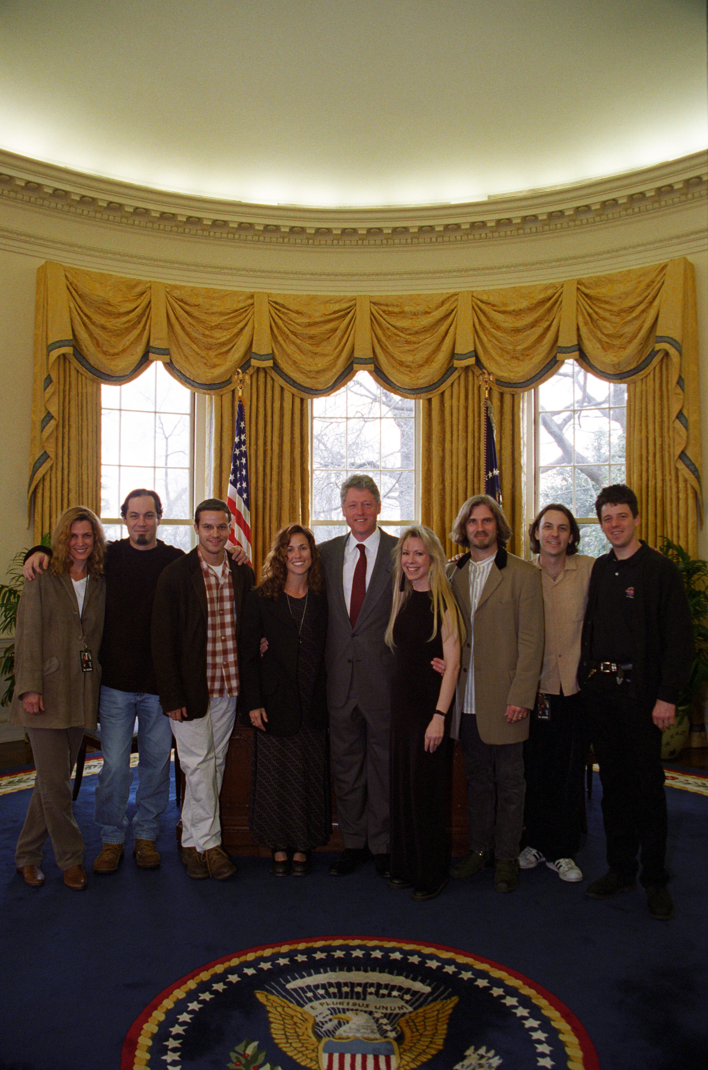 President Clinton poses for a photo with musician Sheryl Crow and her band in the Oval Office