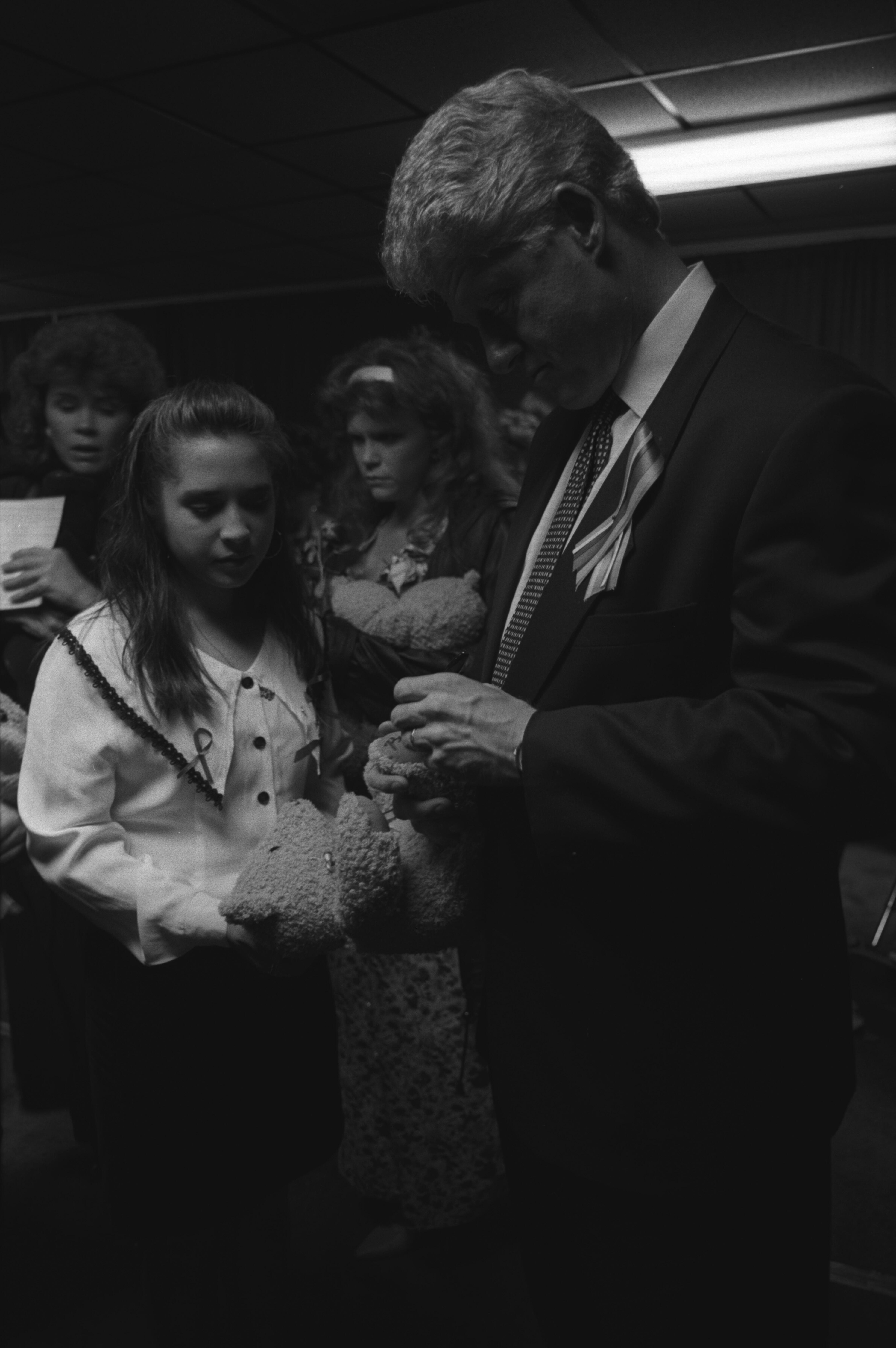 President Clinton receives a teddy bear from a family at the memorial service for victims of the bombing of the Murrah Federal Building in Oklahoma City