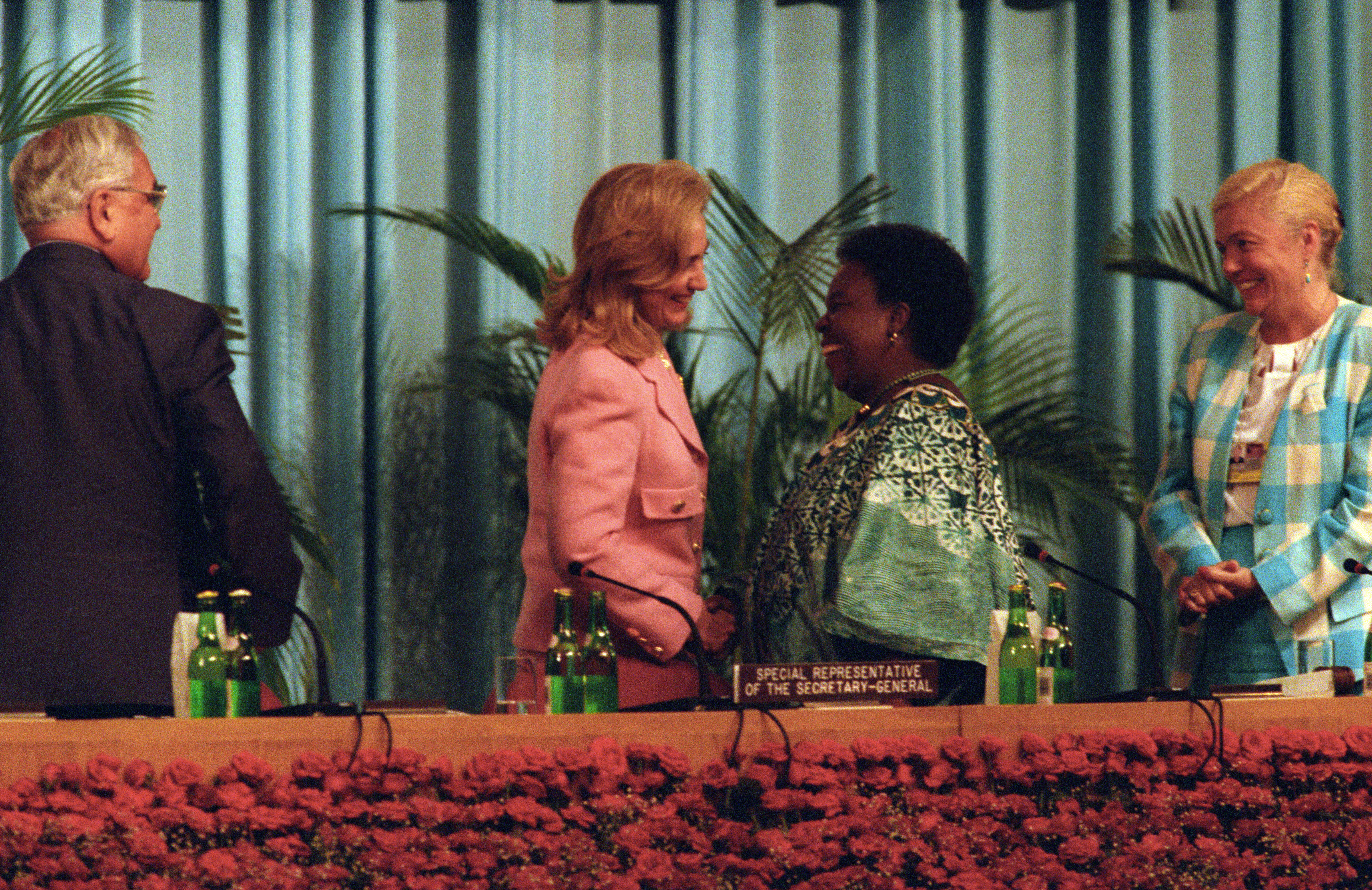 Hillary Rodham Clinton greets Special Representative of the Secretary General, Gertrude Mangella, on stage at the Fourth United Nations Conference on women at the Beijing International Conference Center