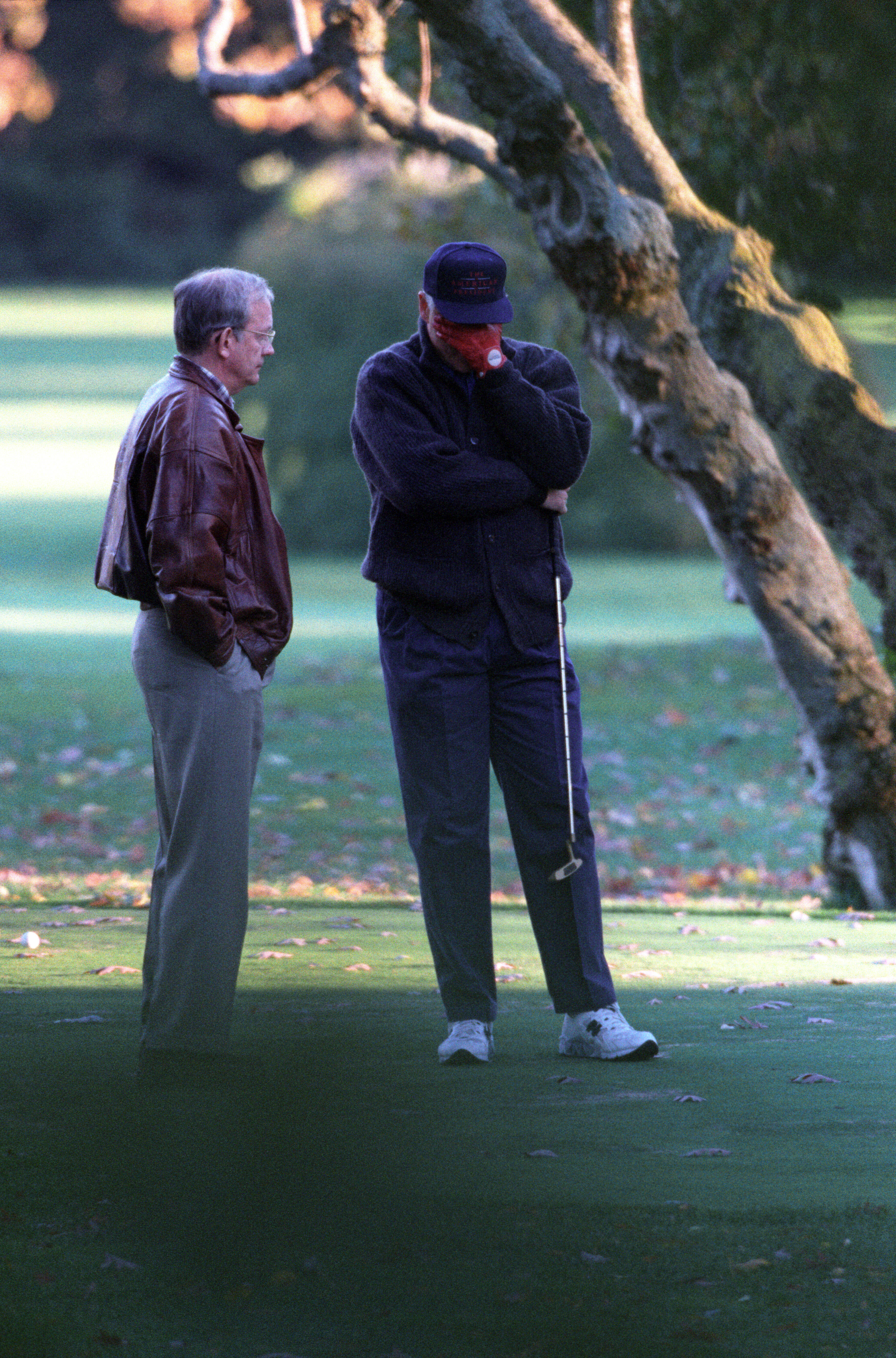 President Clinton practices putting on the White House putting green. He is interrupted by National Security Advisor, Tony Lake, who informs him of the assassination of Prime Minister Yitzahk Rabin of Israel