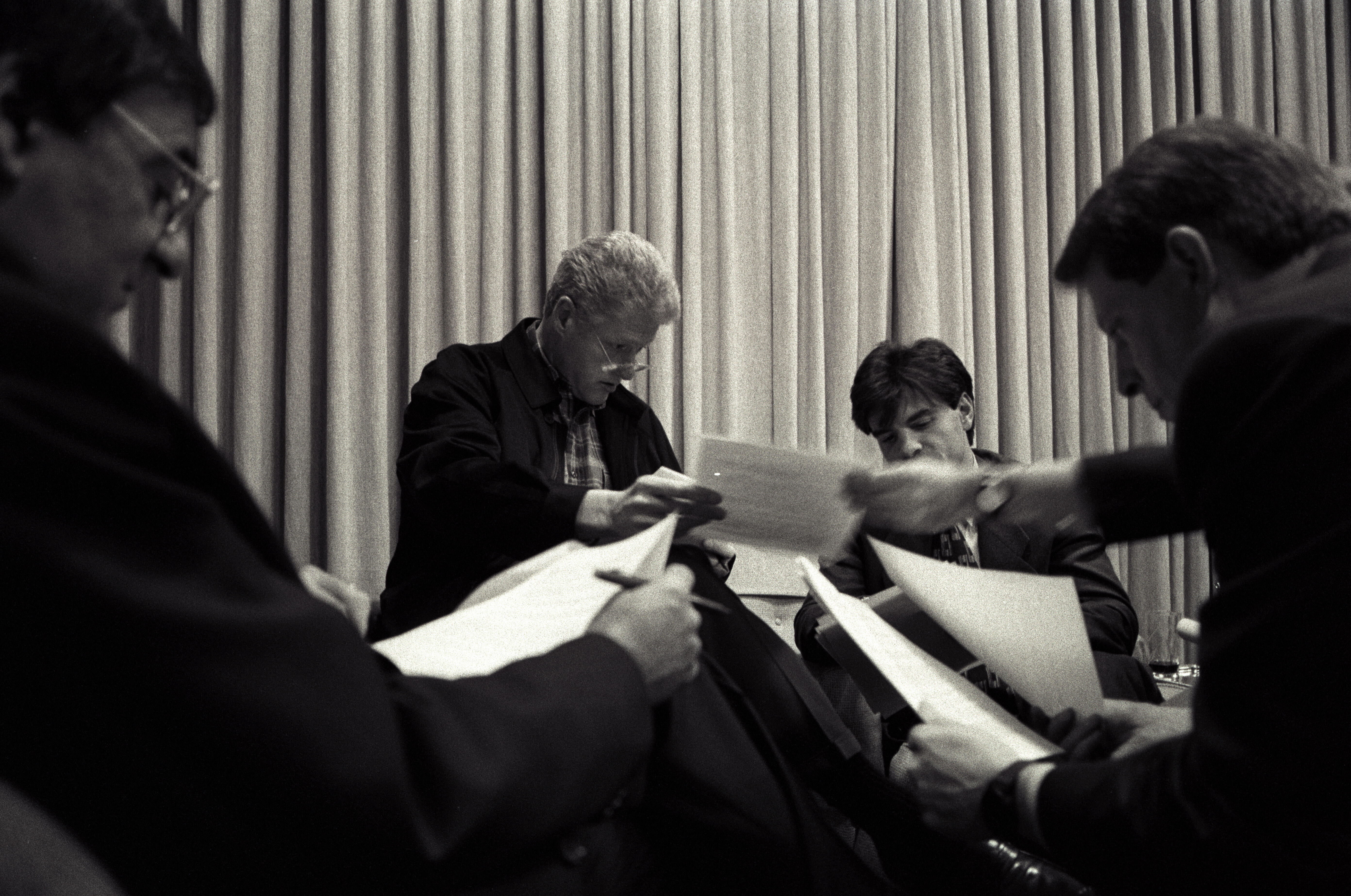 Black and White Photo. President Clinton works on his State of the Union Speech with Vice President Gore, Leon Panetta, and George Stephanopoulos in the Family Theater in the White House