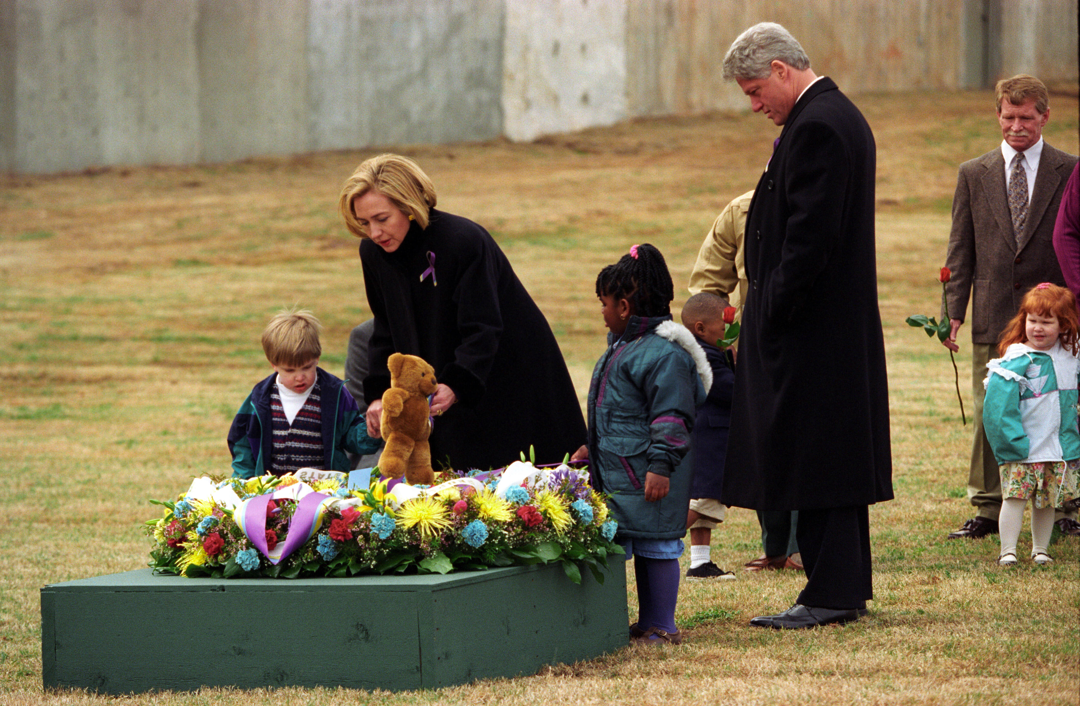 President Clinton and First Lady Hillary Rodham Clinton participate in a wreath laying ceremony with bombing survivors at the former site of the Murrah Federal Building in Oklahoma City