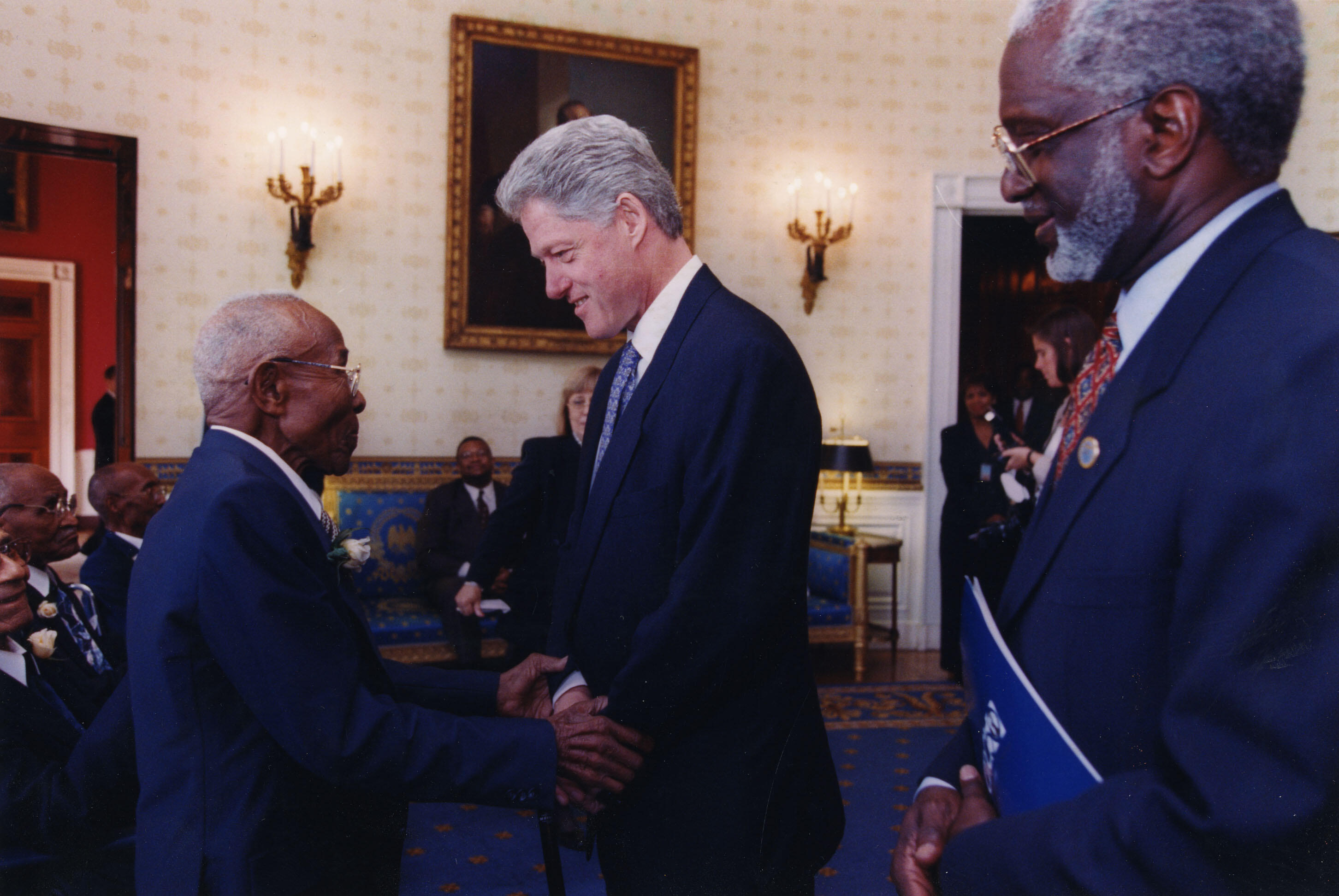 President Clinton stands with a survivor of Tuskegee Syphilis Study on African-American men