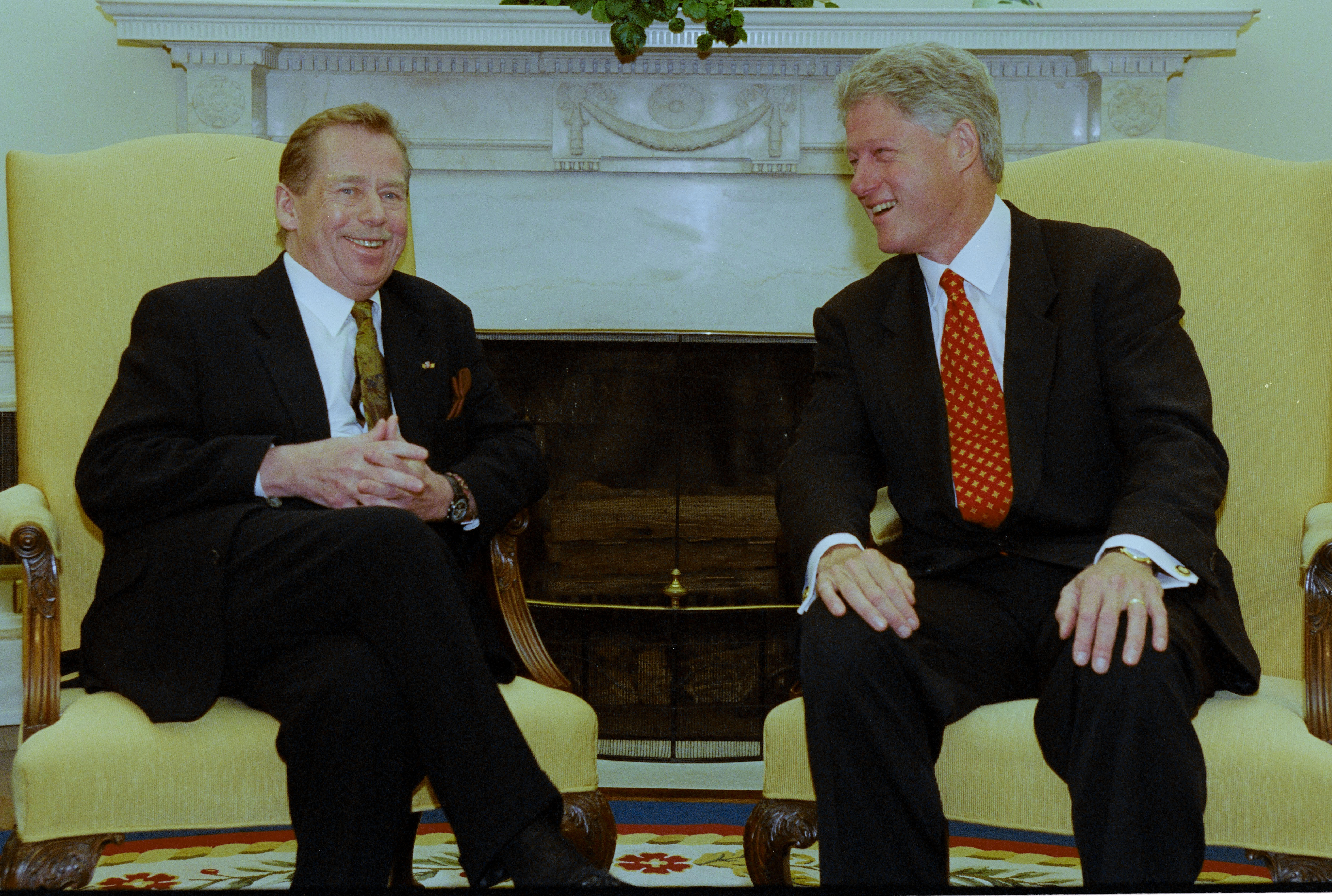 President Clinton and President Václav Havel of the Czech Republic sit on yellow chairs in the Oval Office.