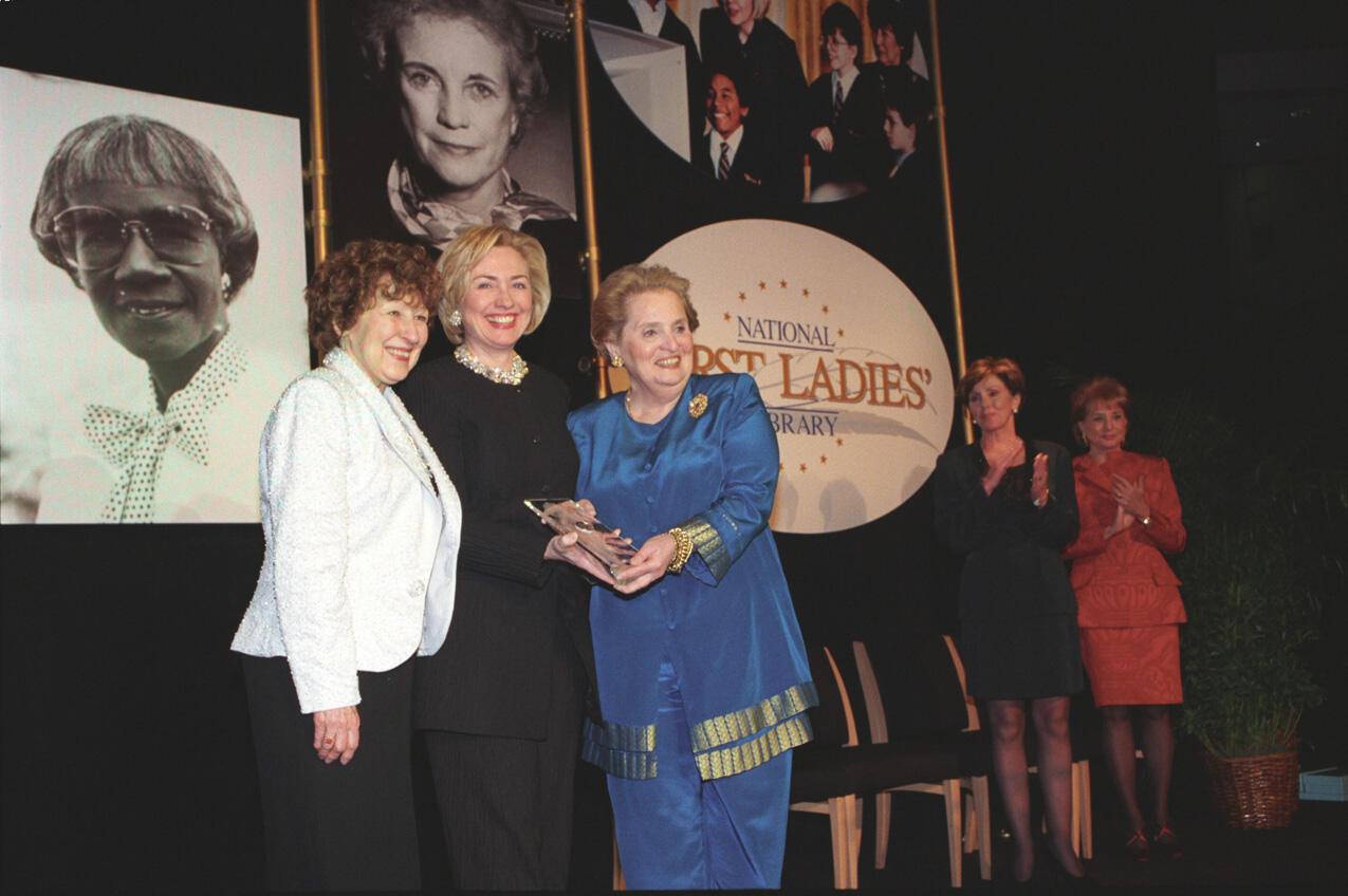 Hillary Rodham Clinton presents an award to Sec. Madeleine Albright at the First Ladies Library Dinner in Washington D.C. 