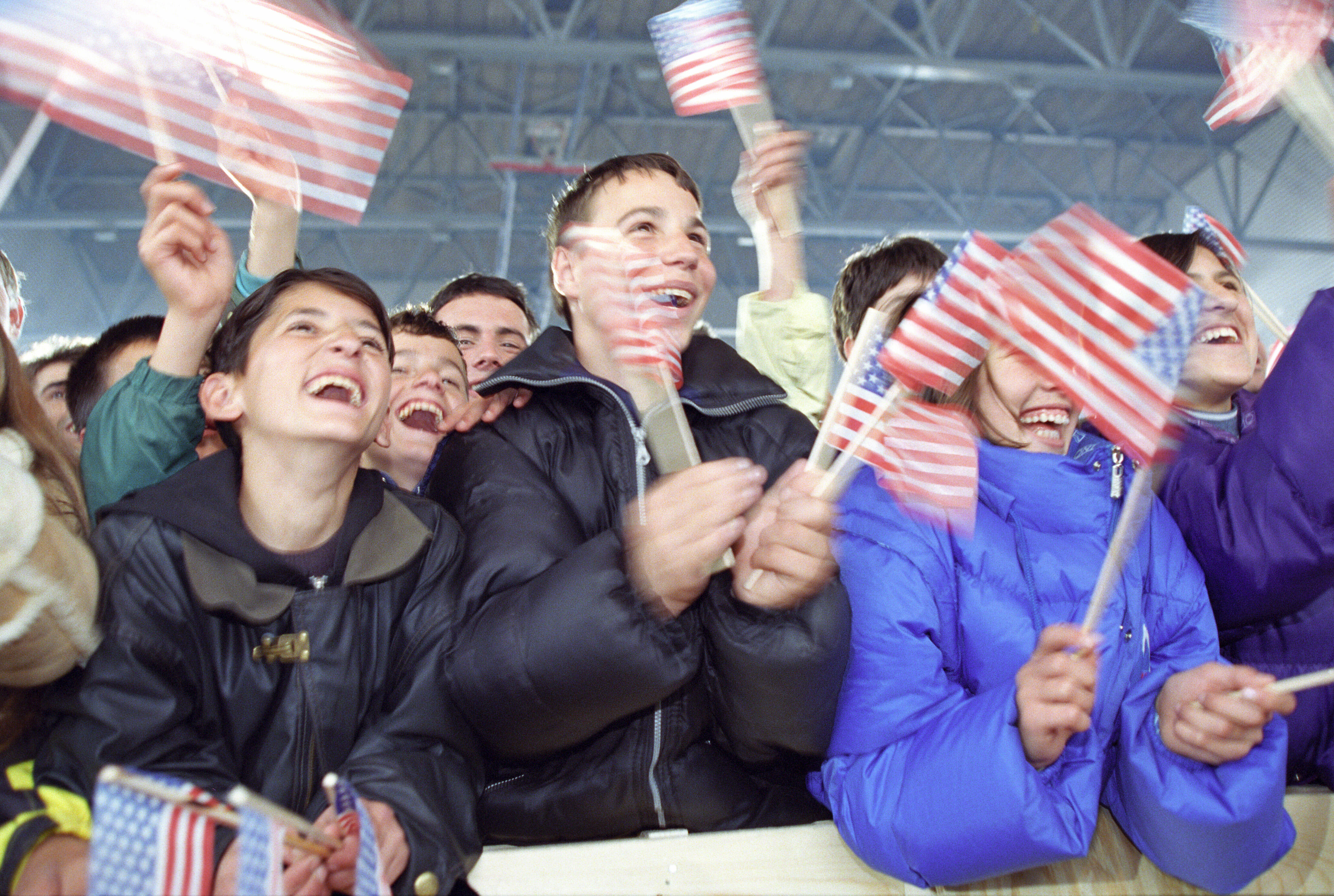 Children wave American Flags at the Ferizaj Sports Pavilion in Ferizaj, Kosovo