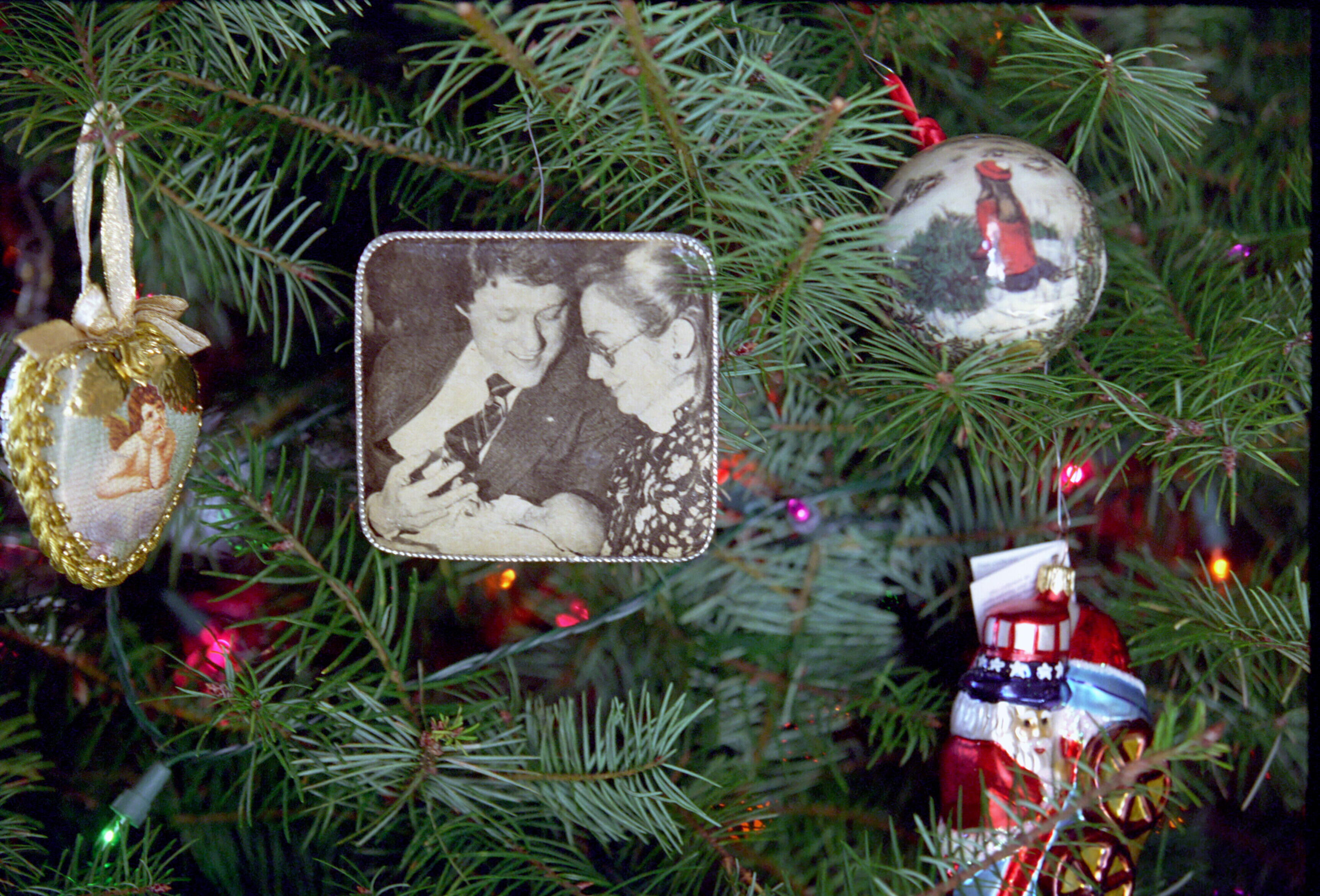 Christmas tree ornament on the Christmas tree in the Yellow Oval Room in the private residence of the White House. The ornament is a 1980 photograph of President Clinton and First Lady Hillary Rodham Clinton holding baby, Chelsea Clinton, in their arms.
