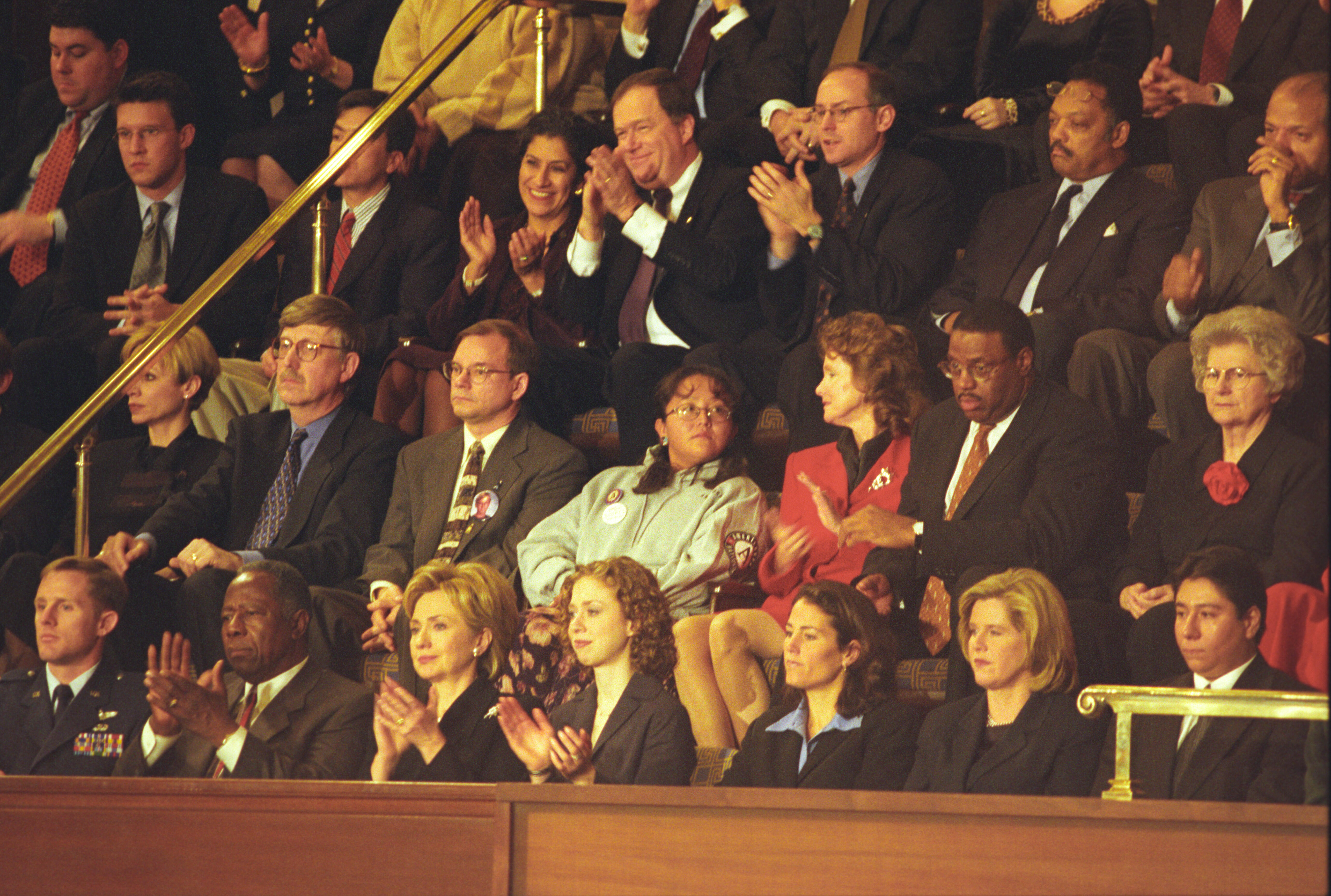 First Lady Hillary Rodham Clinton attends the State of the Union in the House Chamber at the United States Capitol, Washington D.C. She is seated in the visitors gallery with Chelsea Clinton, Hank Aaron, Airforce Captain John Cherry, Dr. Francis Collins, Pat Brown, Julie Foudy, Janet Langhart Cohen and others