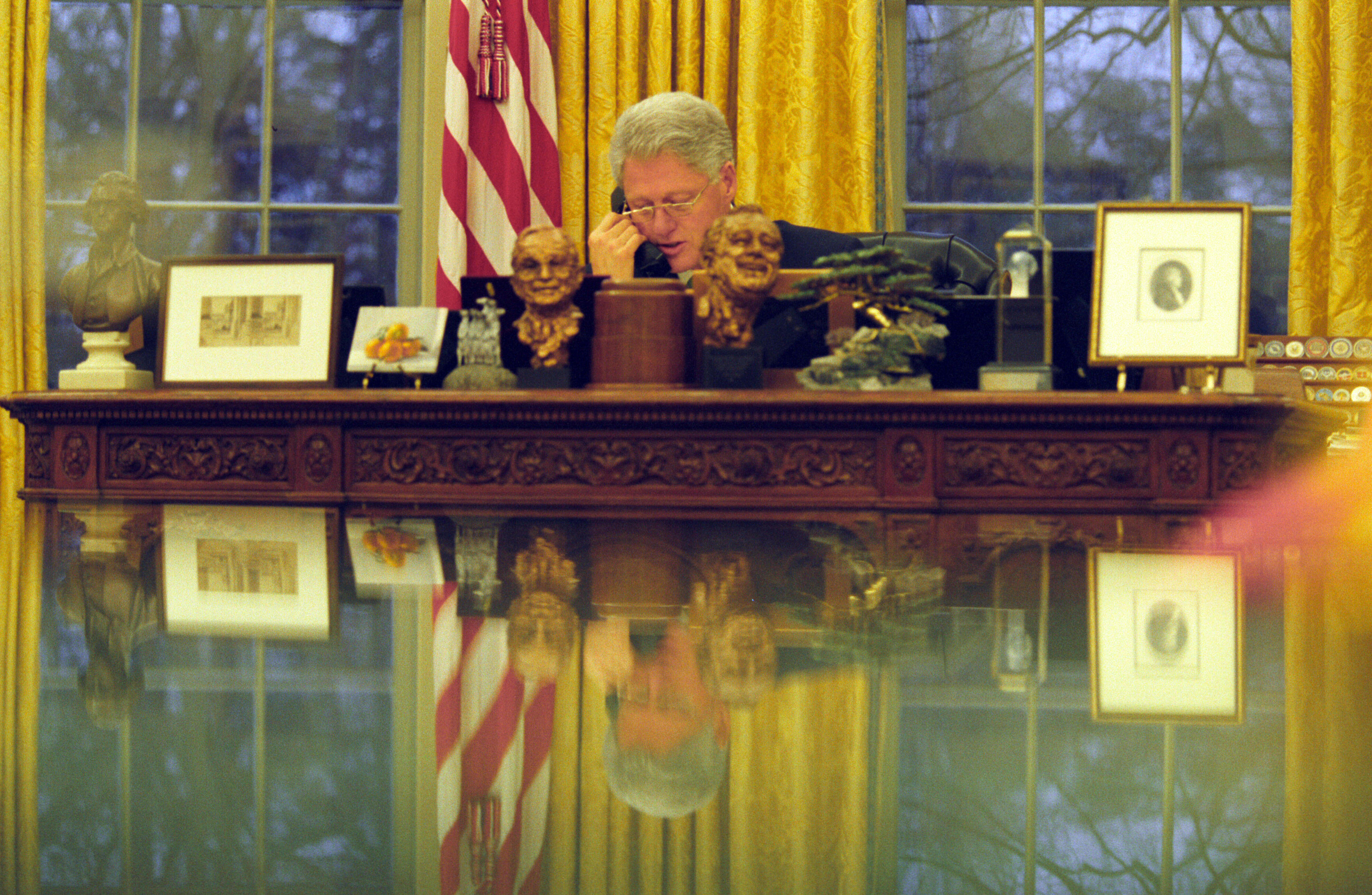 President Clinton talks on the Oval Office telephone with Prime Minister Ehud Barak of Israel