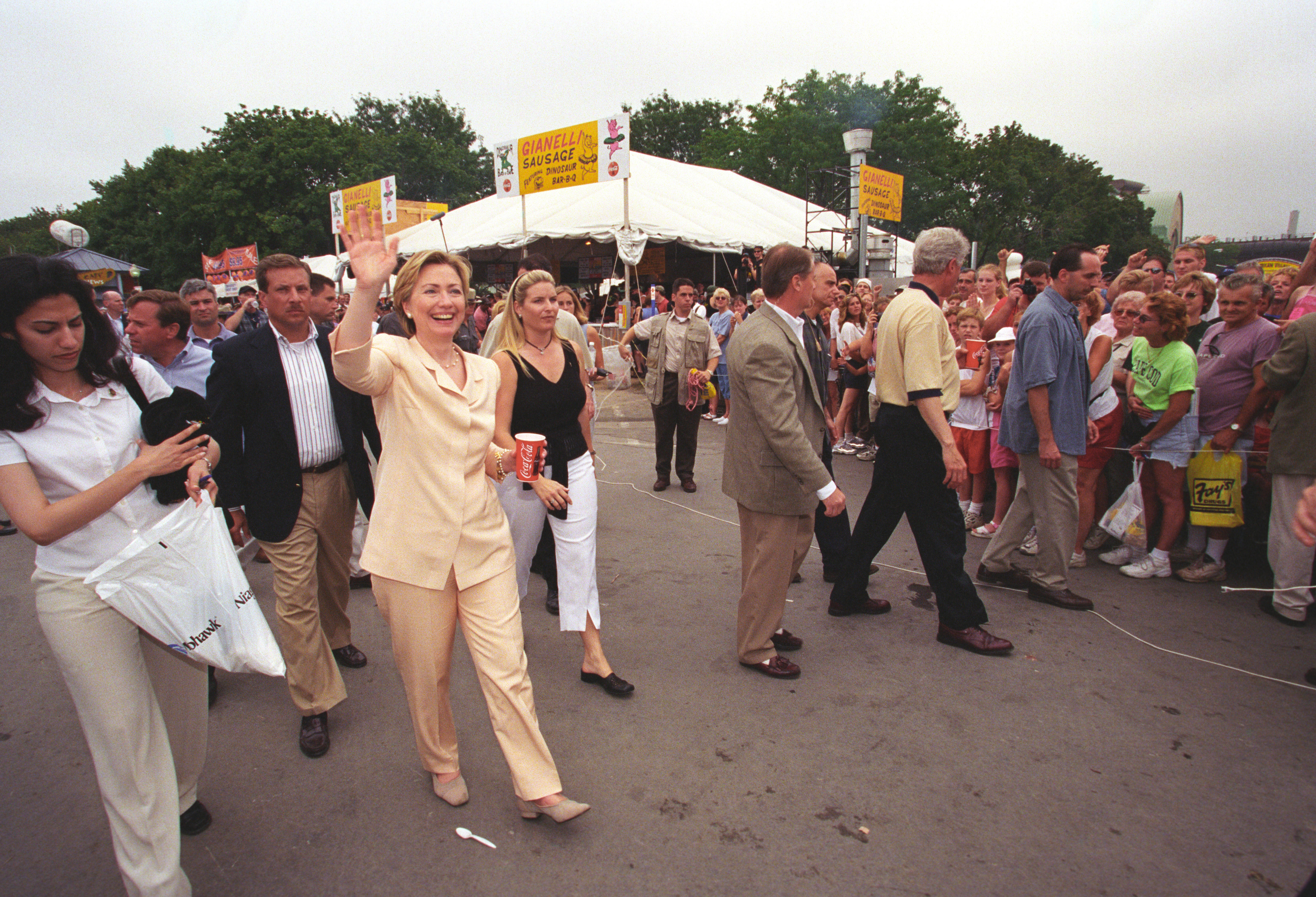 Hillary Rodham Clinton and President Bill Clinton attend the New York State Fair in Syracuse, New York. The First Lady waves at the gathered crowds as she walks at the fairgrounds