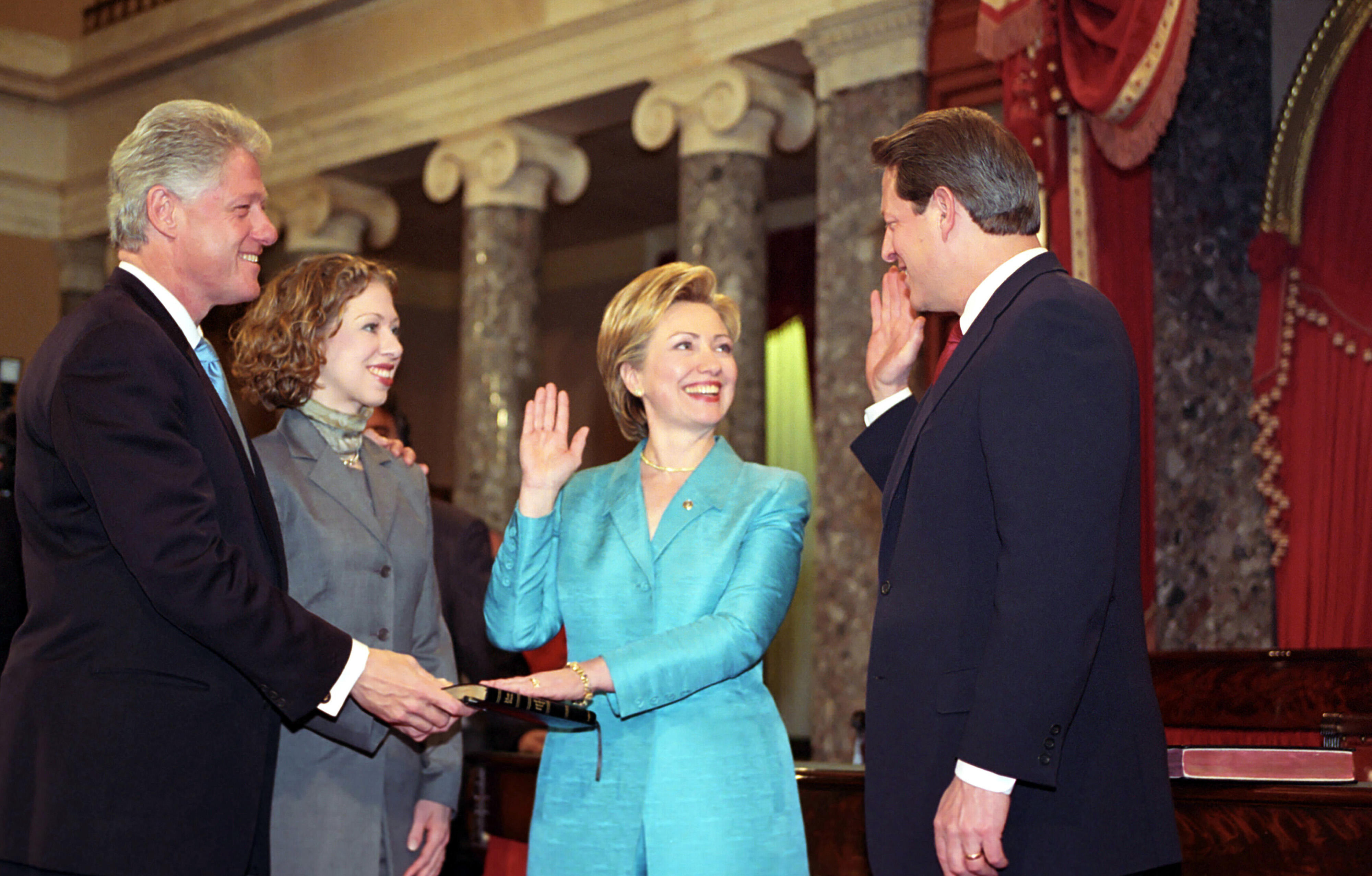 First Lady Hillary Rodham Clinton is sworn-in as a United States Senator for the State of New York. Vice President Al gore administers the oath of office. President Clinton and Chelsea Clinton smile as they hold the bible on which the First Lady takes her oath