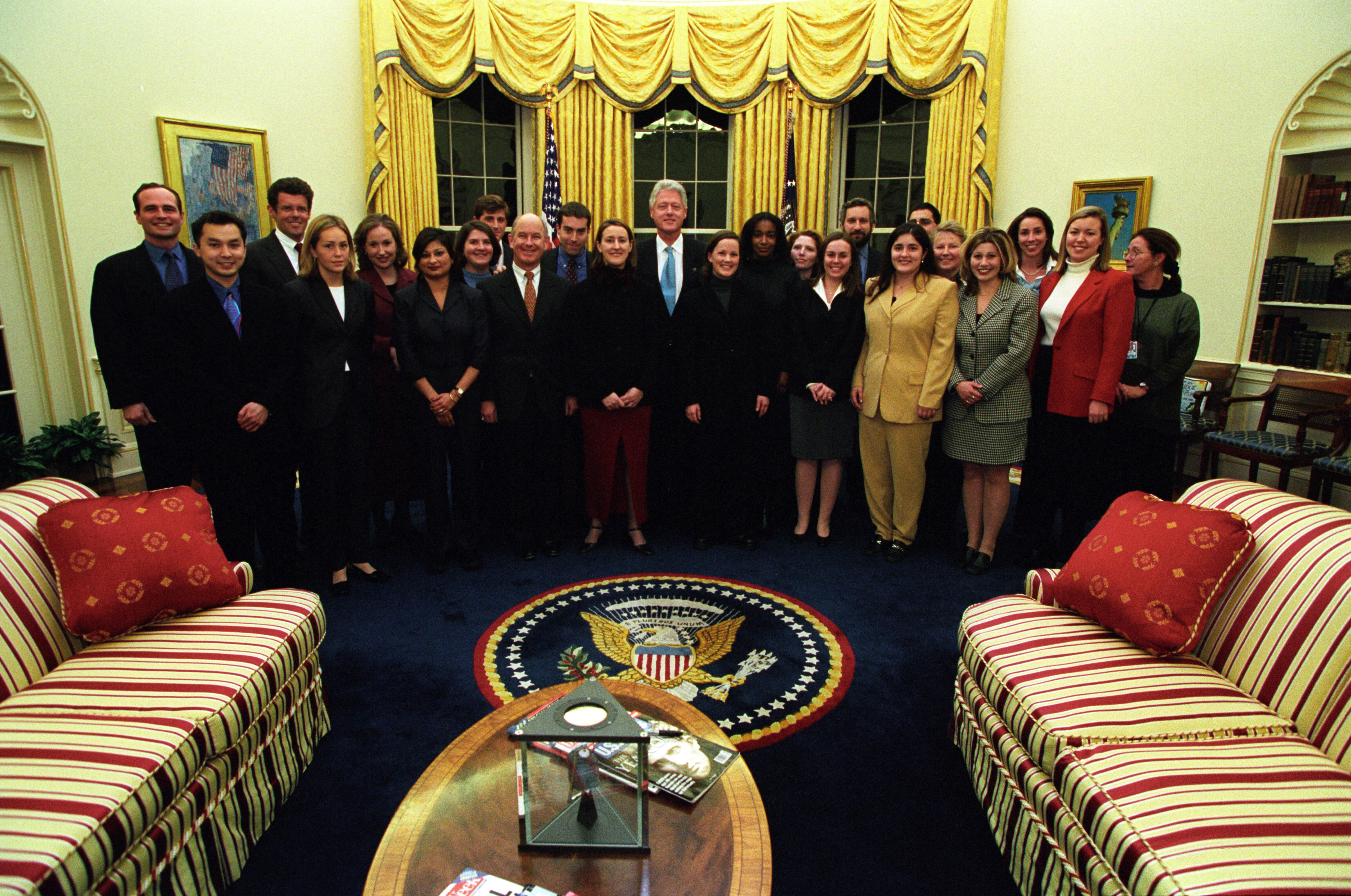 President Clinton joins the staff of the Press Secretary's Office for a group photo in the Oval Office