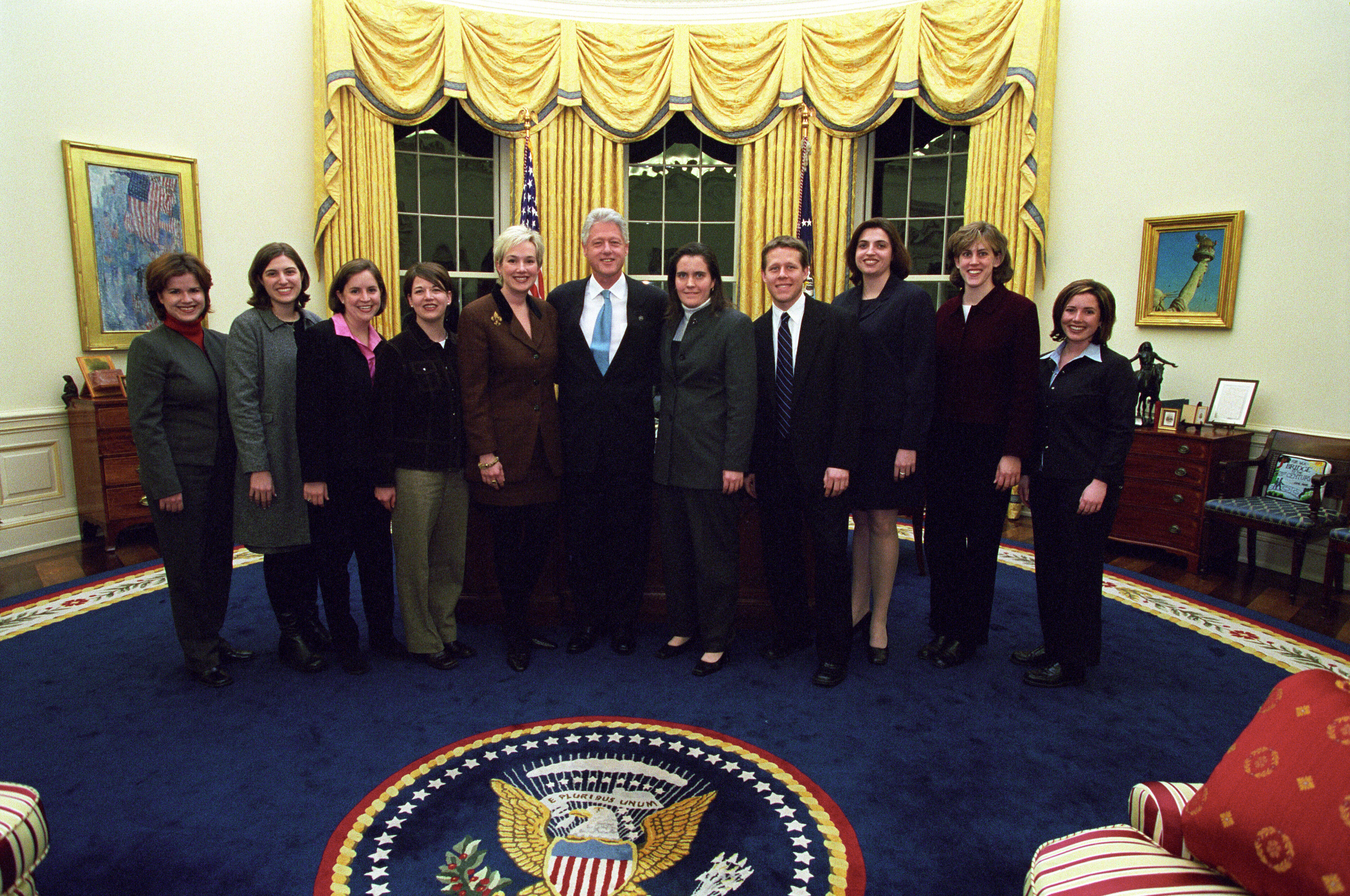 President Clinton joins Stephanie Streett and the staff of the Scheduling Office for a group photo in the Oval Office
