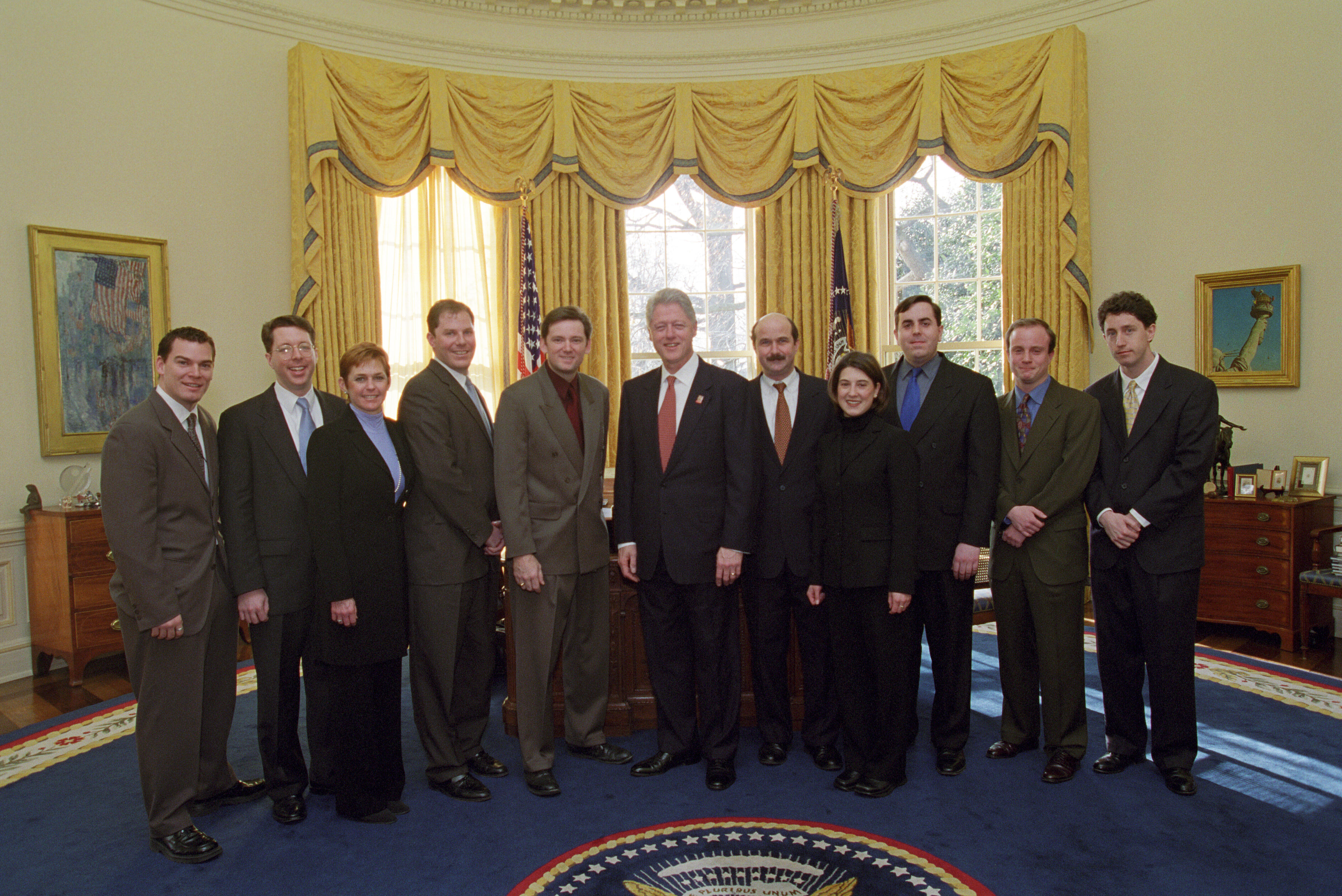 President Clinton joins the staff of the Advance Office for a group photo in the Oval Office