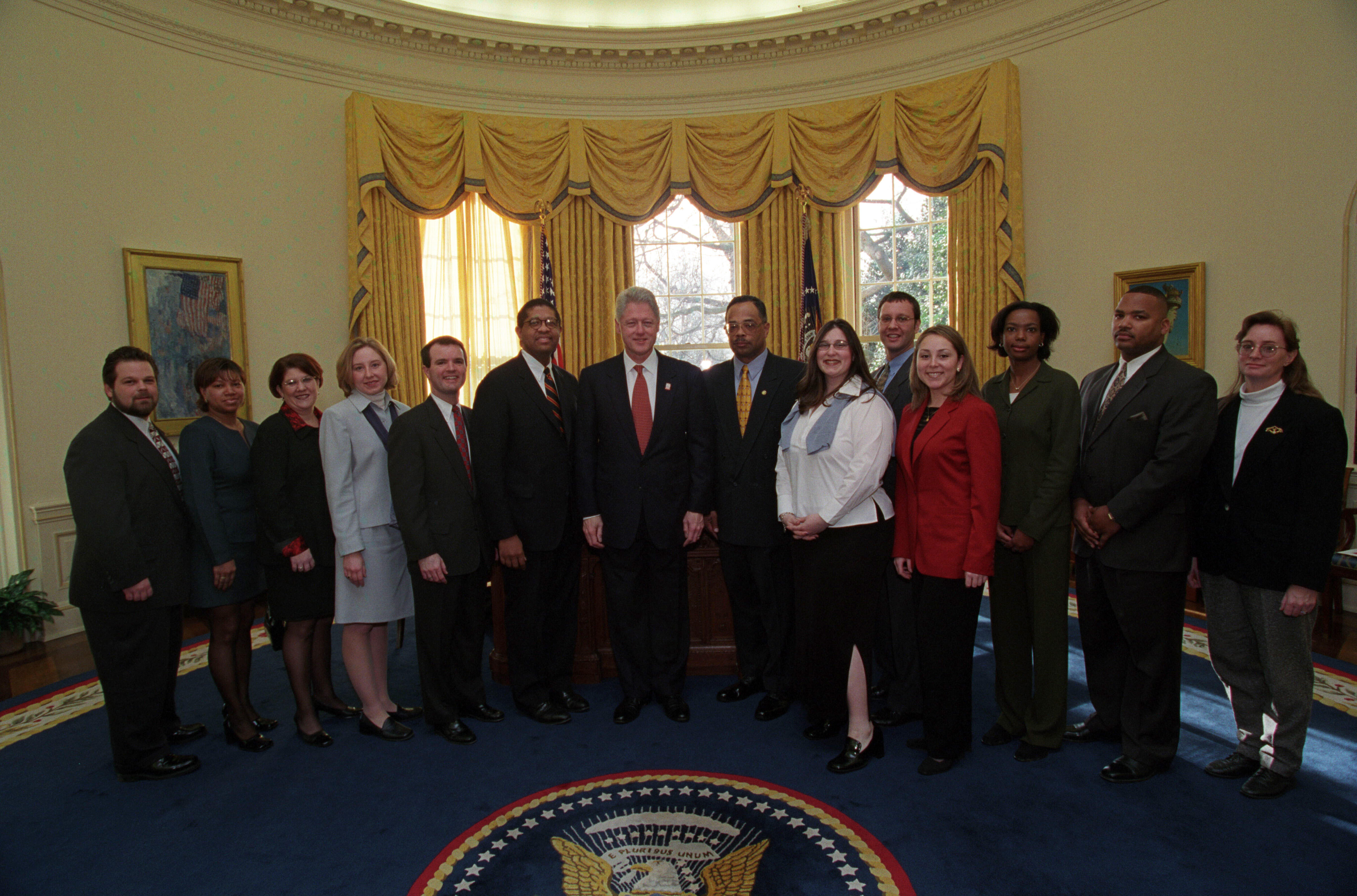President Clinton joins the staff of the Management and Administration Office for a group photo in the Oval Office